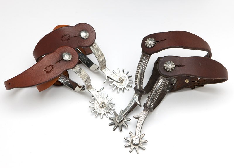 Two pairs of silver overlay spurs: Mid 20th century, the first: California style; the second: Garcia, Elko, Nevada, 4 pcs, est: $400/600