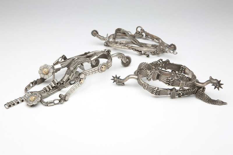 Three pairs of Argentinean silver spurs: One pair with gold, 6 pcs, est: $500/800