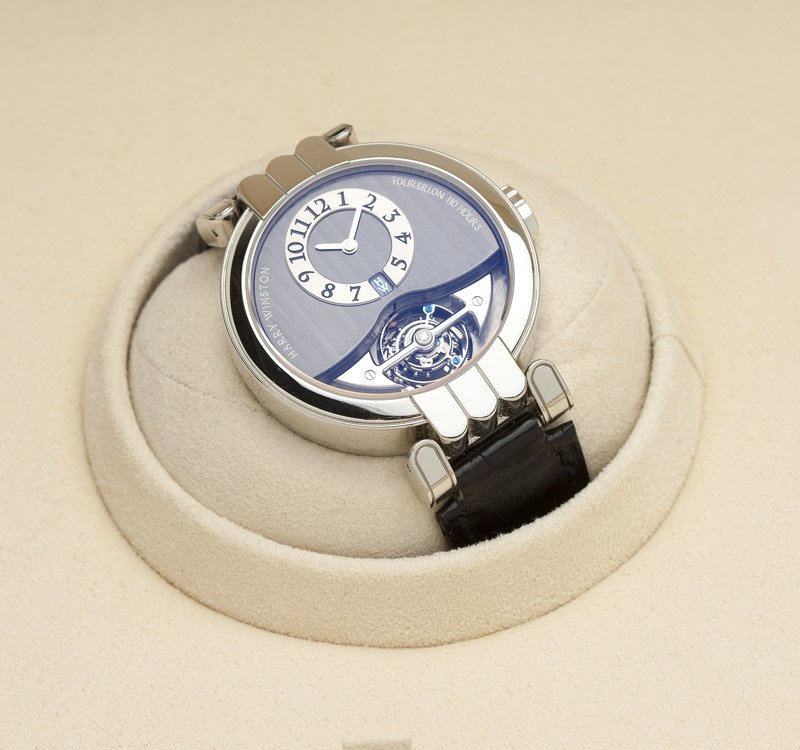 A Harry Winston platinum tourbillon wristwatch: The off-center circular dial signed ''Harry Winston Tourbillon 110 Hours'', with silvered hour ring with Arabic numerals and power reserve indicator at 6 o'clock, above visible tourbillion cage; attac