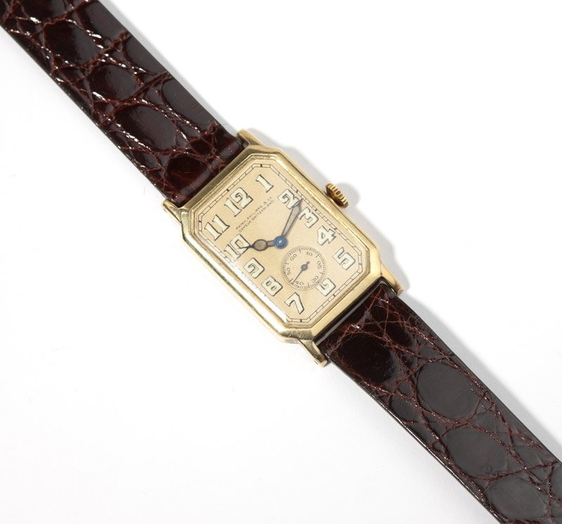 A gent's Patek Philippe 18K gold wristwatch: The rectangular dial signed ''Patek Philippe & Co. Geneva Switzerland'', with black luminous Arabic hour markers, black sub-seconds, and black and luminous hands, attached to an 18 jewel manual moveme