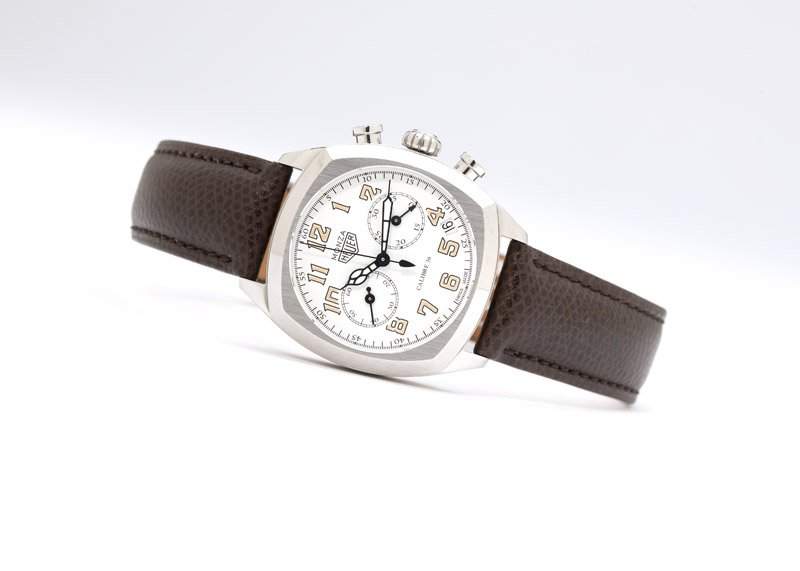 A gent's Tag Heuer Monza date chronograph: The circular white dial signed ''Heuer Monza'' and ''Calibre 36'', with luminous Arabic hour markers, minute track with Arabic 5 minute markers, two sub-dials, and date aperture; attached to a 31 jewe