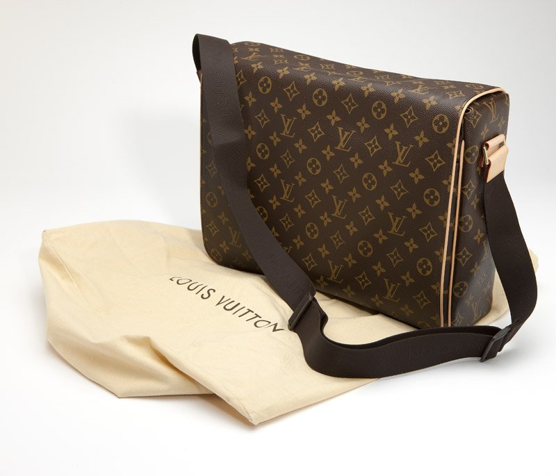 A Louis Vuitton monogram canvas ''Abbesses'' bag: Trimmed in vachette leather, with an adjustable nylon strap, flap top with elastic button closure; the interior of brown canvas with zippered pocket, cell phone pockets, patch pockets and D-ring; all 