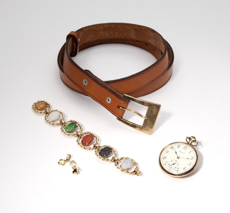 A jade bracelet and collection of gold articles: Comprising: a 14K gold link bracelet with colored carved jade sectionals; two 14K gold cruciform pendants; a gold-filled Shreve & Co pocketwatch; and a leather belt with a 14K buckle; 84.2 gms gross,