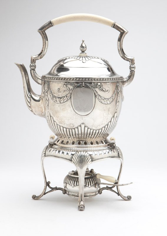 A German .800 silver tipping kettle: Late 19th / early 20th century, the kettle hallmarked to base, maker's mark of Bruckmann and Sohne, the stand and burner not marked, of oval form, the finial, hinged lid and body partially gadrooned, 