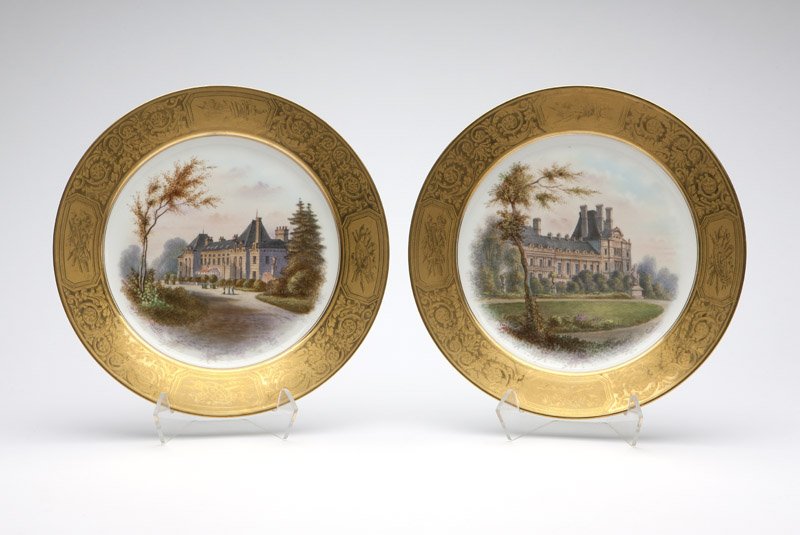 Two Sevres style porcelain plates: Mid - late 19th century, each with green printed mark ''S. 48.'', each signed ''Guillon'', the first titled ''Tuileries: Pavillon de Flore'', the second titled ''Chateau de la Malmaison'', each circul