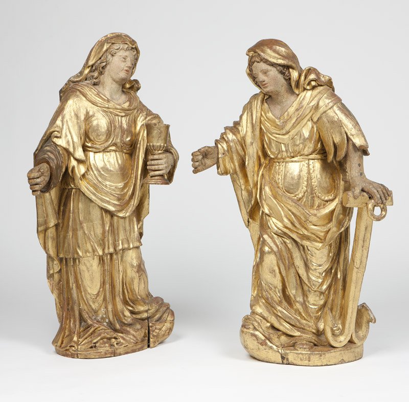 Two Continental carved giltwood figures: 19th century, each depicting a standing female saint, the first holding a chalice, the second leaning upon an anchor, 2 pcs, the first: 43.5'' H x 24'' W x 11'' D, the second: 42'' H x 26.5'' W x 9'' 