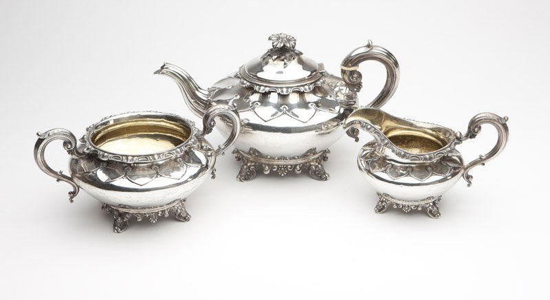 A Victorian sterling silver tea set: 1837 - 1842, London, makers mark of Edward Barnard and Sons, an assembled partial service comprising: a teapot dated 1837 (6'' H x 11.25'' W x 6.75'' D), a sugar or waste bowl dated 1838 (4.25'' H x 8