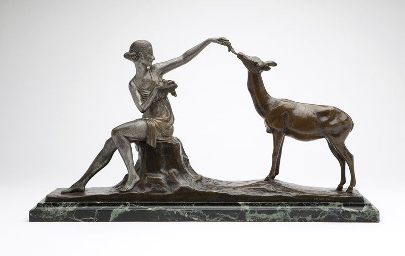 Marcel-Andre Bouraine (1886 - 1948 French): signed ''BOURAINE'' and ''Etling. Paris'', depicting a seated maiden feeding a deer, patinated and silvered bronze, on a stepped marble plinth, the bronze alone 11'' H; overal 12.25'' H x 23.5'' W x 5