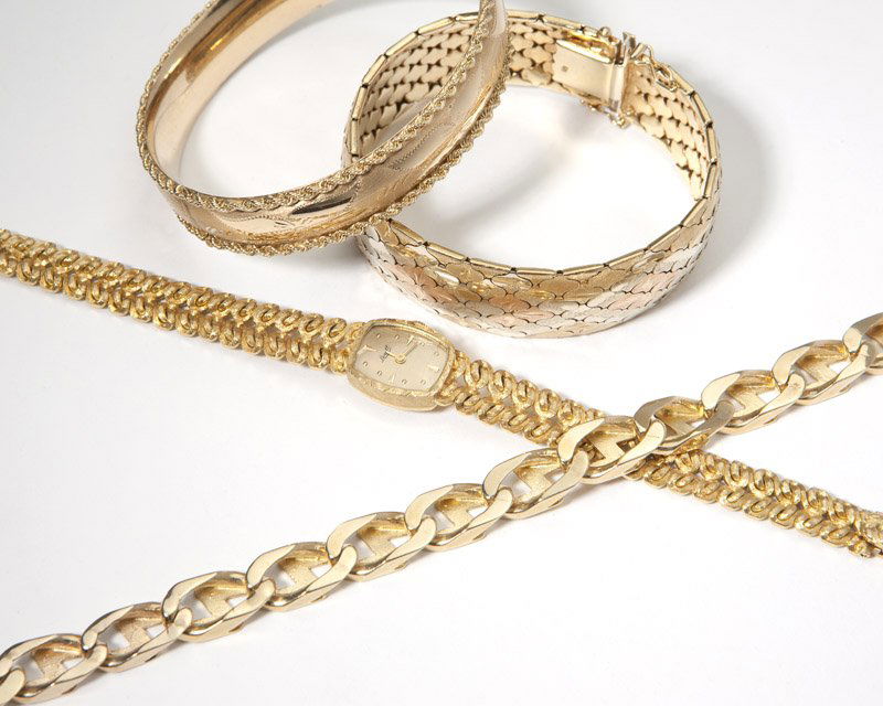 A group of gold bracelets and a watch: All 14K gold, featuring one bangle, one tri-tone mesh bracelet, one link bracelet and one 18K gold fancy link wristwatch, dial signed 'Lorett', movement signed 'Perfine Watch Co', 17 jwl unadjusted, 1