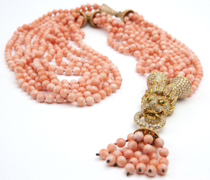 A coral, diamond and gold necklace: 18K gold, centerpiece clasp signed 'LARRY', a multi-strand coral bead necklace with two bracelet convertible sectionals, 8'' each, later attached to a diamond-set dragon's head centerpiece with coral
