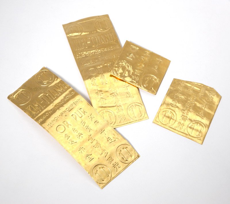Vietnamese high karat gold wafers: Two intact wafers, and two broken pieces, in original wrappers, 44.6 gms, est: $800/1200 Provenance: These were given to the current owners family during the Vietnam War for aid and services rendered