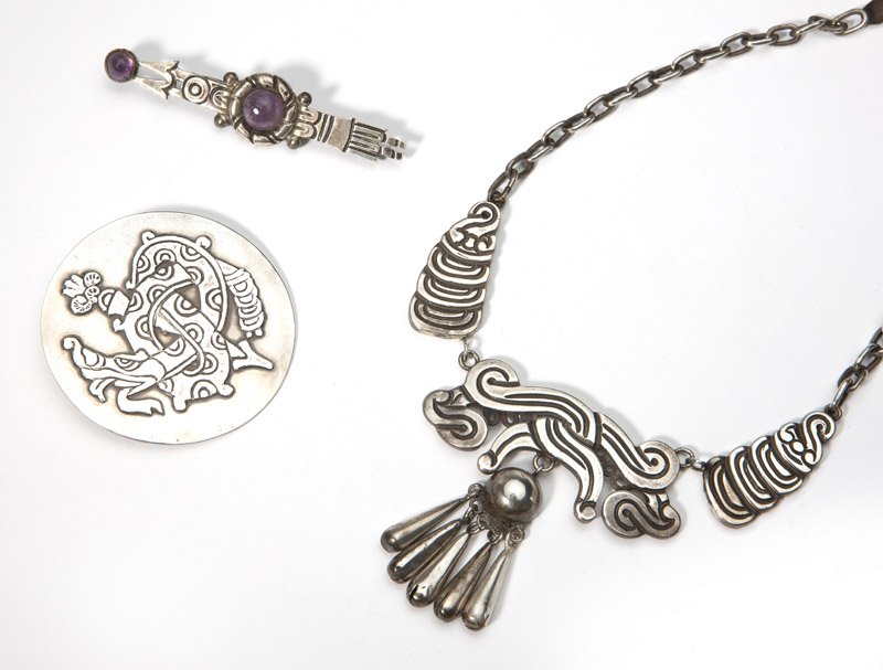 A group of William Spratling silver jewelry: Stamped ''Spratling Silver'', comprising: a circular Aztec serpent brooch; an arrow bar brooch with amethyst cabochons; and a necklace with five central drops stamped Spratling, 15'', est: $600/800 Pr