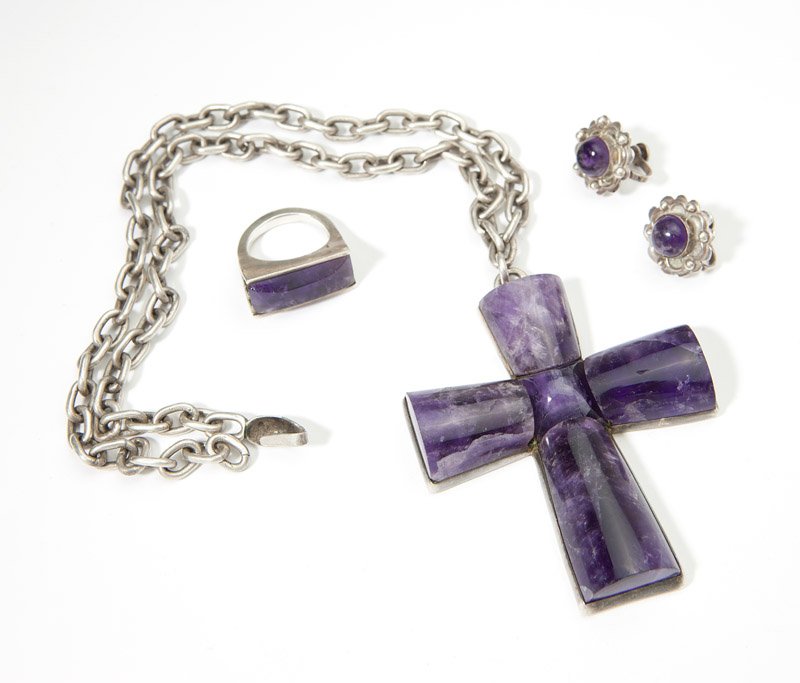 A group of Mexican silver and amethyst jewelry: Signed for William Spratling, sterling silver, a large 2.75'' amethyst cruciform with chain together with an amethyst ring and a pair of amethyst screw-back earrings, neither signed, chain 20'', size