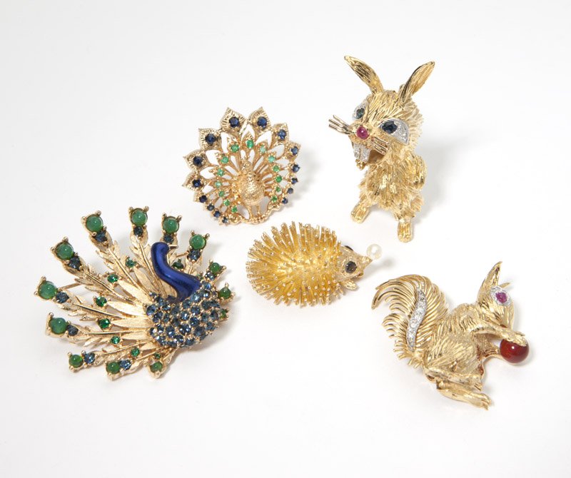 Group of five animal brooches: Comprising two in 18K gold signed ''Kutchinsky'', one of a squirrel holding a carnelian ball with ruby eyes and diamond accents, the other of a rabbit with ruby nose, sapphire eyes and diamond accents