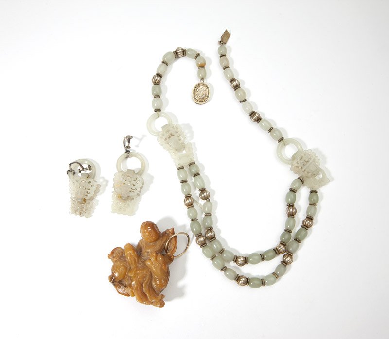 A collection of carved serpentine: A beaded and carved greenish white serpentine necklace with matching screw-back earrings together with a russet serpentine figural pendant, 4 pcs, est: $400/600
