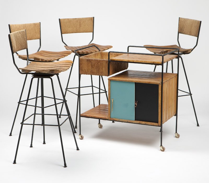 A bar cart & four stools by Arthur Umanoff for Raymor: 1950s, each of wooden slats and woven rush on iron frames, the cart with sliding blue, orange and black masonite doors with leather pulls and a removable white masonite base to basket, 5 pcs, the cart
