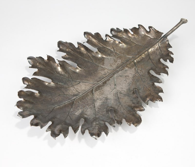 A Buccellati sterling silver dish: After 1968, Milan, with registration mark, further marked ''Fabrico Buccellati'' and '''925'', naturalistically modeled as an oak leaf, on foliate feet, 3'' H x 16'' W x 10.5'' D, 16.8 oz troy approxi