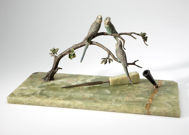 A cold-painted bronze & green onyx pen stand: Late 19th / early 20th century, the rectangular base mounted with three polychrome-painted birds perched on a branch and a holder for a pen, together with a green onyx letter knife, 8.5'' H x 18'' W x