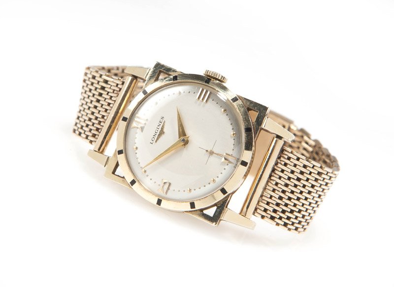 A gent's gold square case wristwatch, Longines: The round silvered dial signed 'Longines' with applied gold tone company winged logo, with applied gold tone Roman numeral and applied dot hour markers, and sub-seconds dial, attached to a 17 jewel ma
