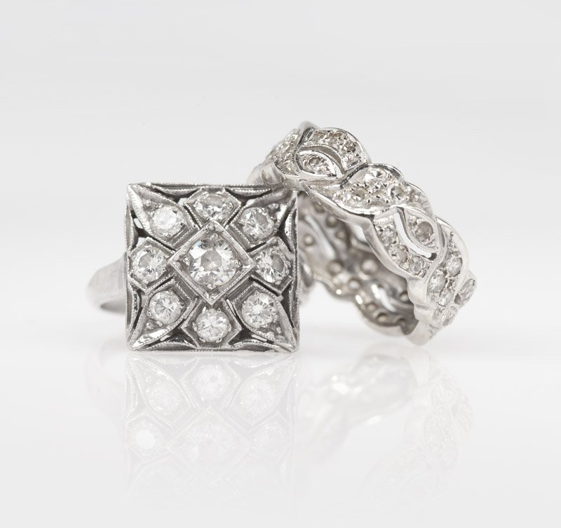 A diamond and platinum ring and a white gold band: The platinum ring square, set with nine full-cut diamonds totaling approximately 0.95 ct; the 14K white gold band set with single-cut diamonds, size 7, est: $800/1200