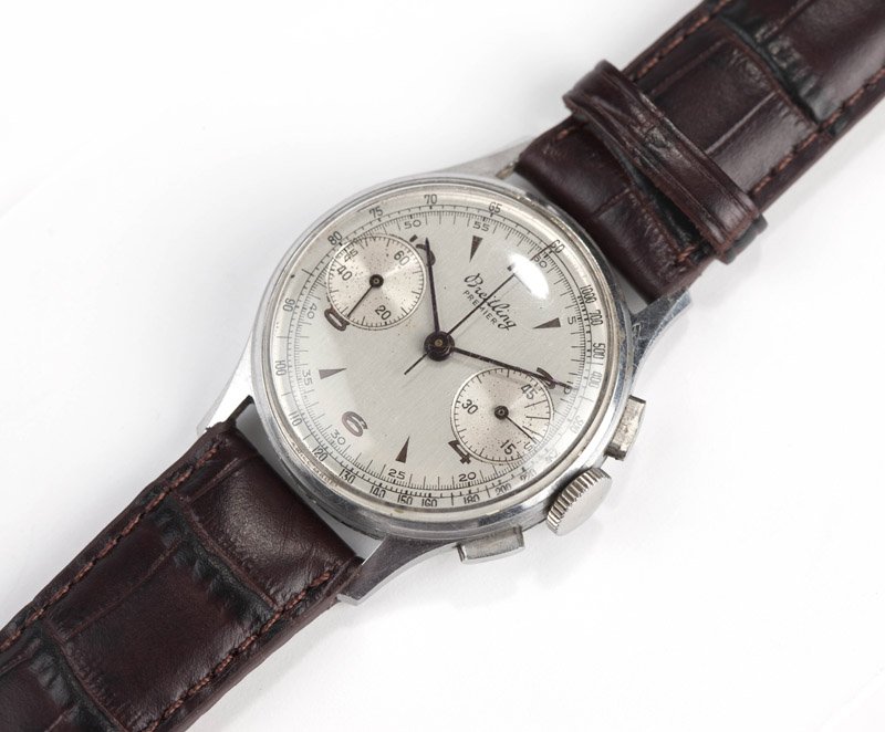 A gent's Breitling Premier chronograph wristwatch: The round silvered dial signed 'Breitling Premier', with two sub-dials on the 3 and 9 o'clock for continuous seconds and minutes, copper toned Arabic hour markers, outer black KMH & Telemeter scales, 