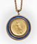 A blue glass and gold coin pendant necklace