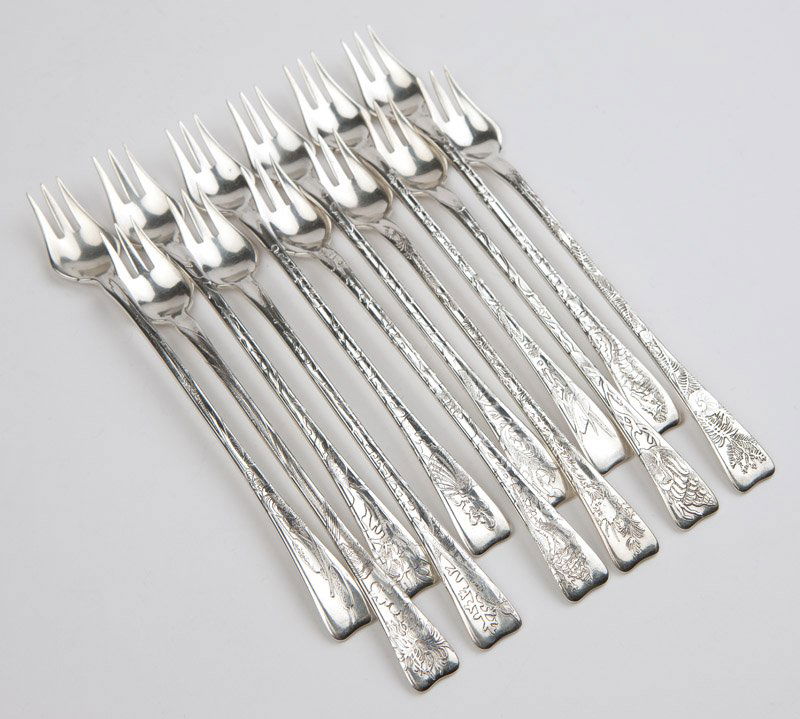 12 Tiffany & Co. sterling silver ''Lap Over Edge'': Circa 1902 - 1907 (each with maker's mark for directorship of Charles T. Cook), each marked ''Tiffany & Co. Sterling Pat 1880'', each distinctly decorated and titled to back of handle, one with ''catt
