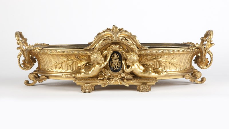 A Napoleon III gilt bronze jardiniere, H. Picard: Mid 19th century, stamped to numerous mounts and body ''H. Picard'' for maker Henri Picard, (Paris 1840 - 1890), the dual-handled oval body with inset copper liner, decorated to each side with a pair