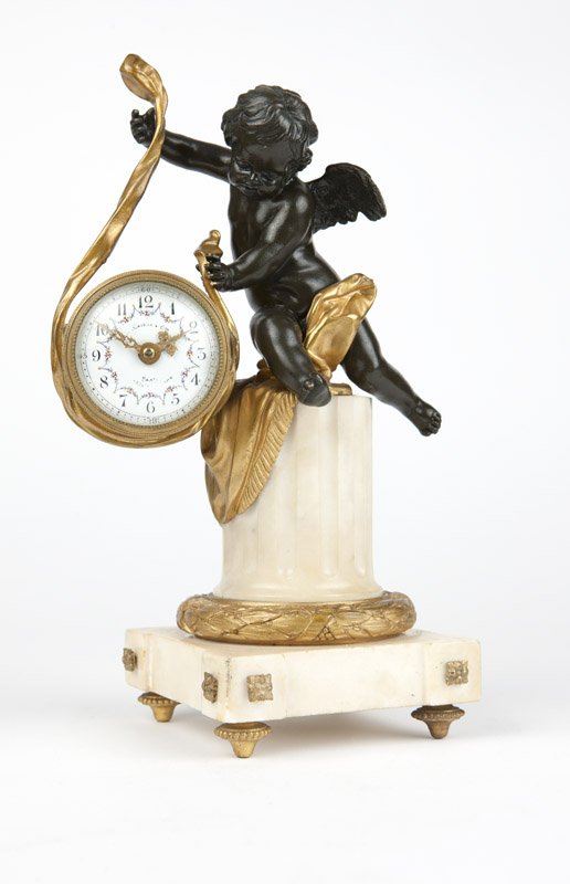 A Louis XVI style white marble and gilt bronze clock: Mid 19th century, the dial signed ''(?) Caisso & Cie / Paris / (?)'', impressed to back plate ''3139'', single train time only movement, modeled as a patinated putti holding aloft a gilt bronze tapest