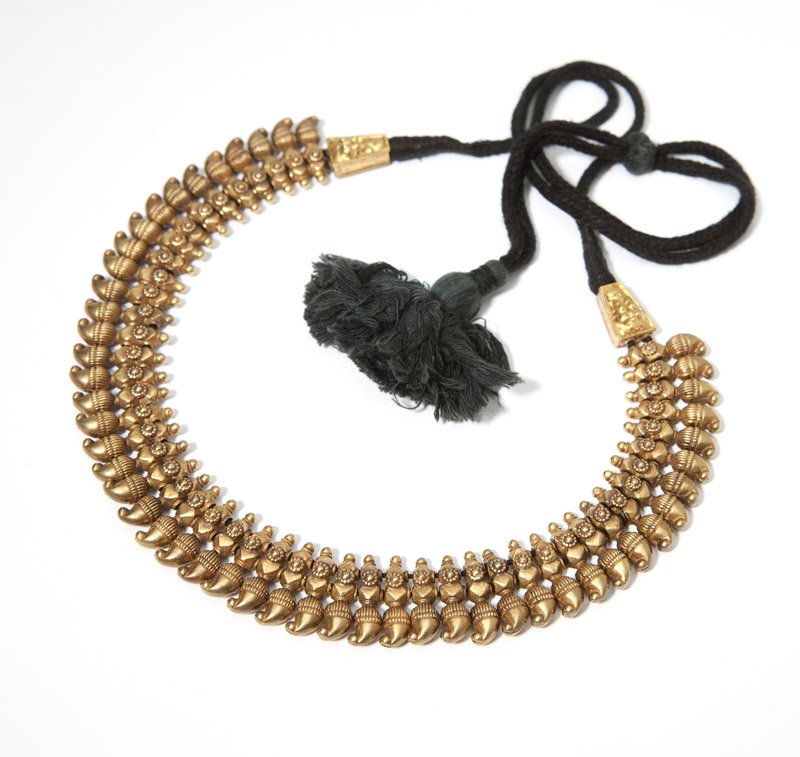 An Indian gold sectional necklace on black cord: 18K gold, consisting of 50 individual links, 10'' of gold links on adjustable cord, 54.5 gms, est: $1200/1800