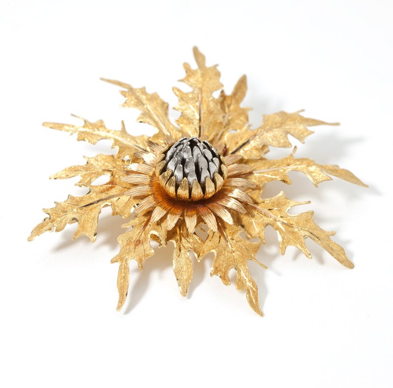 A gold thistle brooch, Buccellati: Signed Buccelati, Italy, designed with tri-colored 18K gold, 2 1/4'' x 2 1/4'', 19.3 gms., est: $1500/2000