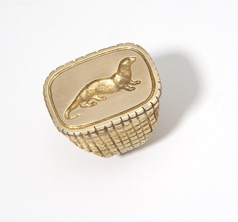A gold otter signet ring: An 18K gold rectangular-shape signet ring centering a gold intaglio of an otter, size 9 1/2, 43.2 gms, est: $900/1200