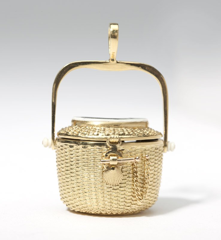 A gold Nantucket basket pendant: 18K gold, with a carved bone tablet engraved with a whale on top, opening to reveal a heart attached to chain inside, 1 3/4'' x 1 1/4'', 31.5 gms gross, est: $700/900