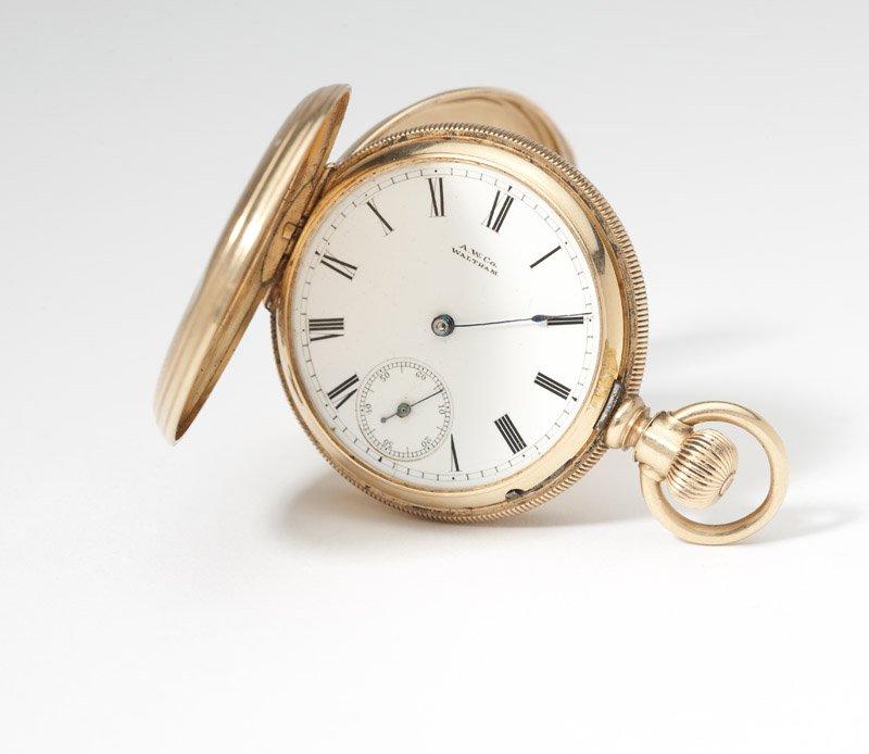An American Waltham Royal gold pocket watch: Circular white porcelain dial with Roman numeral hour markers, sub seconds, signed 'A.W. Co Waltham', attached to a signed Am. Watch Co. Royal movement, stem wind lever set, No: 2230970, within a 14K 