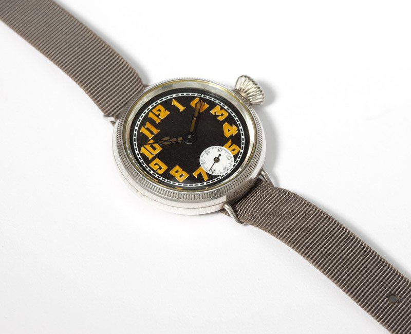 An early Rolex silver wristwatch: A circular black dial with luminous Arabic hour markers, white sub-seconds, attached to a 15 jewel manual-wind movement signed ''Rolex'', within an English sterling silver case, rear lid hallmarked fo
