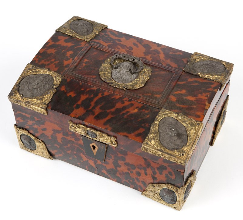 A Danish gilt bronze-mounted tortoiseshell box with: Late 19th / early 20th century, the domed rectangular tortoiseshell-clad cover centered by a pierced foliate C-form handle over a gilt bronze-framed white metal portrait medallion, with further portra