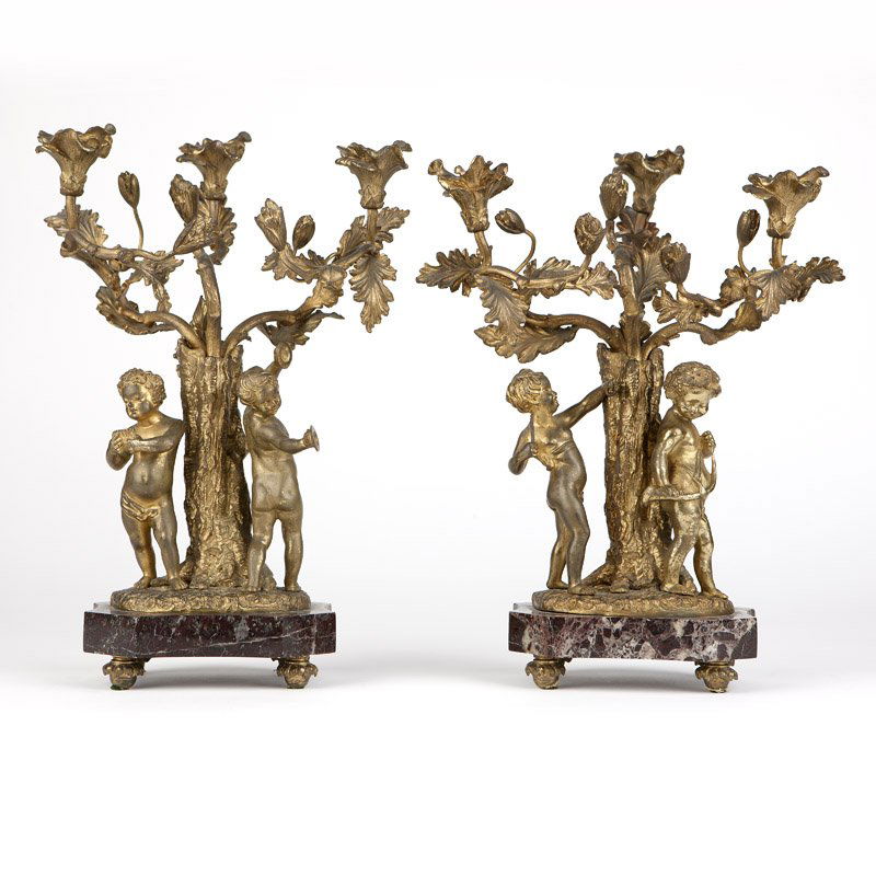A complementary pair of three-light gilt bronze figural: Late 19th / early 20th century, likely French, each with three poppy-form sockets issuing from stem-form arms adorned with poppy buds and leaves, rising from a tree trunk base flanked by two standing