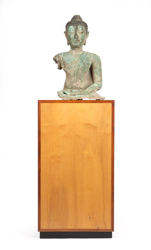 A partial Thai bronze Buddha Shakyamuni: Circa 17th century, Sukhothai style, the Buddha modeled seated, left hand on his lap, palm facing upwards, raised overall on a contemporary plinth, the Buddha: 26'' H x 15'' W x 12.5'' D, est: $1000/2