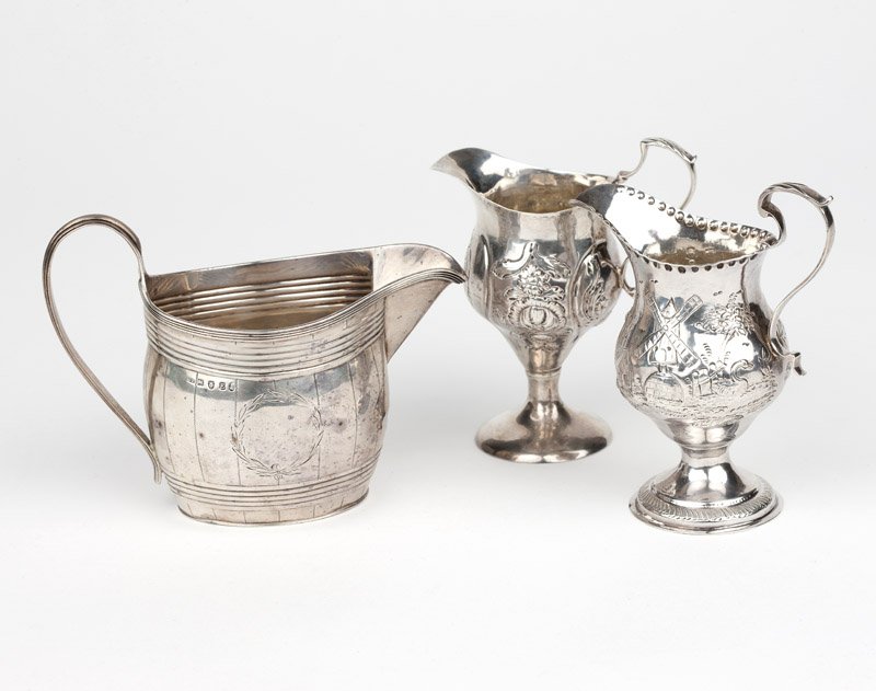 A group of 3 Georgian sterling silver cream pots: Each London, the first: 1800, with partially rubbed maker's mark ''CF'' for Crispin Fuller, a repousse-decorated barrel-form cream pot with chased laurel wreath reserves to each side (4.125'' H x 5.75