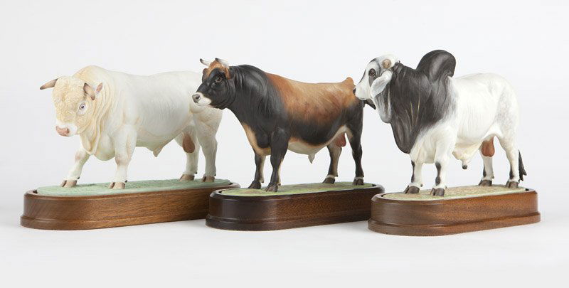 Three Royal Worcester porcelain models of bulls: Introduced 1965-1968, each with maker's marks, dated and titled to underside, three polychrome painted porcelain bulls modeled by Doris Lindner, each with a wooden base and accompanied by COA, includi