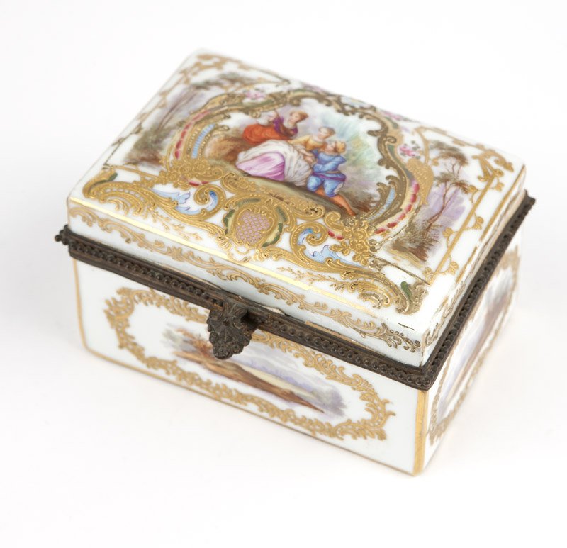 A polychrome dresser box, Marx Eugene Clauss: Last quarter 19th century, French, with maker's blue underglaze crossed swords and initial mark, the hinged gilt bronze-mounted domed rectangular top hand-painted with figures in a verdant landscape w