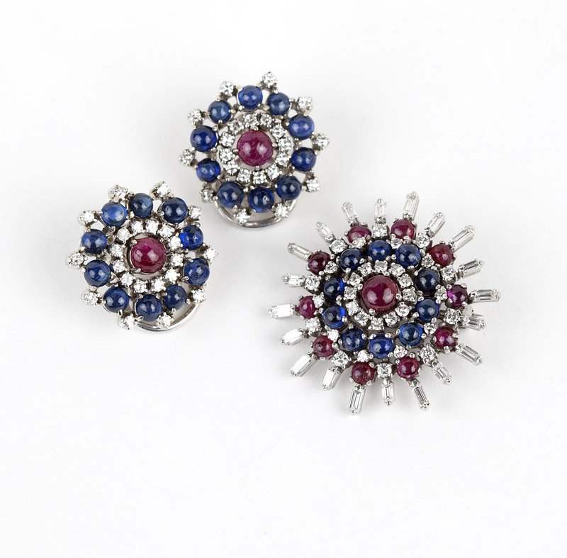 A set of sapphire, ruby and diamond jewelry: Tested 14K white gold circular brooch and matching earclips set with ruby and sapphire cabochons and circular and baguette-cut diamonds totaling approximately 2.40 cts, 22.8 gms gross, est: $2500/3500
