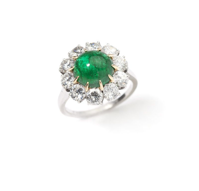 An emerald and diamond ring, Van Cleef & Arpels: Stamped with French assay marks for platinum and 18K gold, signed Van Cleef & Arpels #106365, centering a round cabochon emerald gauged at approximately 1.85 cts and surrounded with ten full-cut round