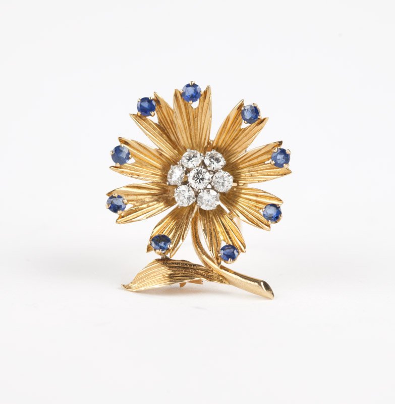 A gem-set flower brooch, Van Cleef & Arpels: With French assay marks for 18K yellow gold and platinum, signed Van Cleef & Arpels #76557, centering seven full-cut round diamonds totaling approximately 0.70 ct and graded F-G color and VS clarity,