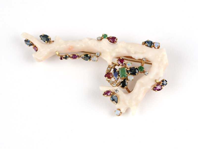 A gold, white coral branch and gem brooch: 18K gold frame with a branch of white coral, accented with various shapes of colored gems, 3 1/4'' x 1 3/4'', est: $700/900