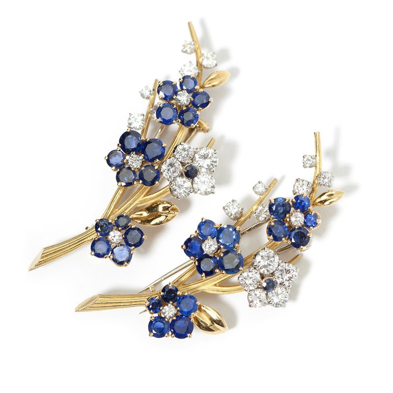 A pair of flower brooches, Van Cleef & Arpels: French assay marks for platinum and 18K yellow gold, signed Van Cleef & Arpels #3102501 and 99427 750; set with 28 full-cut round diamonds totaling approximately 2.75 cts, graded E-F color and VS clar
