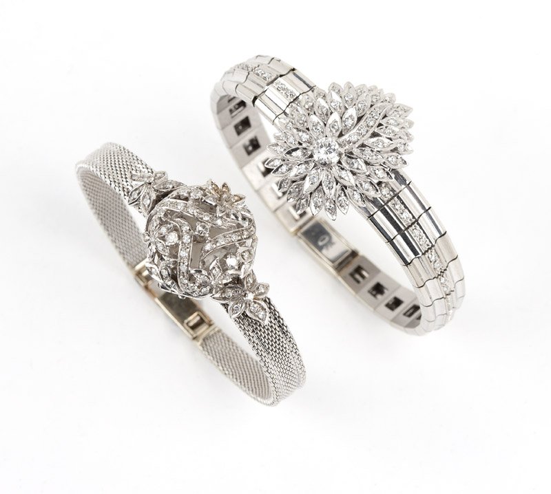 A group of two lady's covered dial wristwatches: First: an 18K white gold lady's Longiness hidden dial wristwatch with a free-form hinged cover with inset diamonds, opens to reveal a round white dial with attached baton hour markers, signed ''Longin
