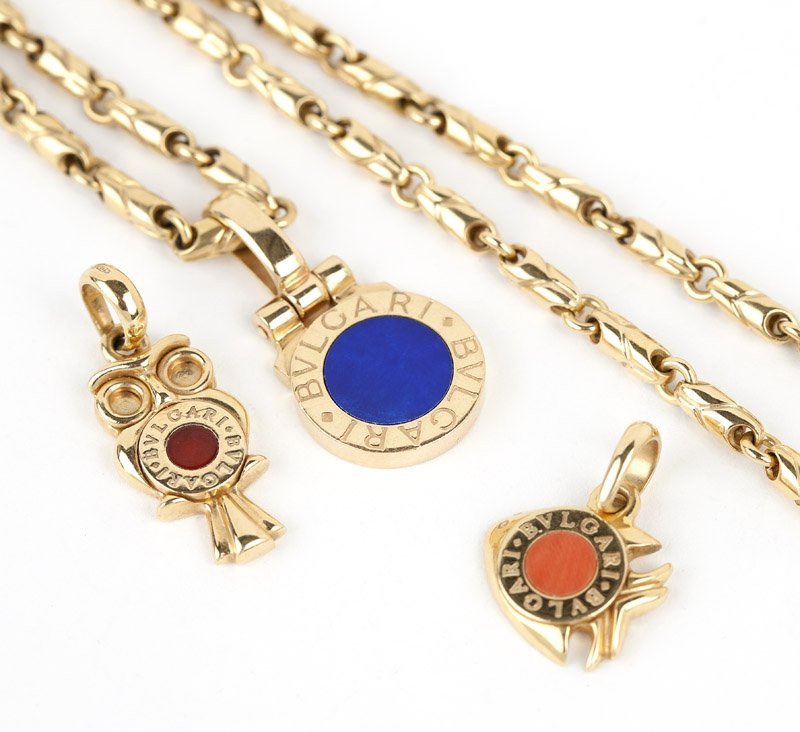 A gold chain with pendants, Bulgari: Stamped 750, Made In Italy, ''Bvglari-Bvglari'', 18K gold chain with three interchangable pendants of lapis and two coral, 55.1 gms gross, 16 1/4'', with box, est: $1800/2250