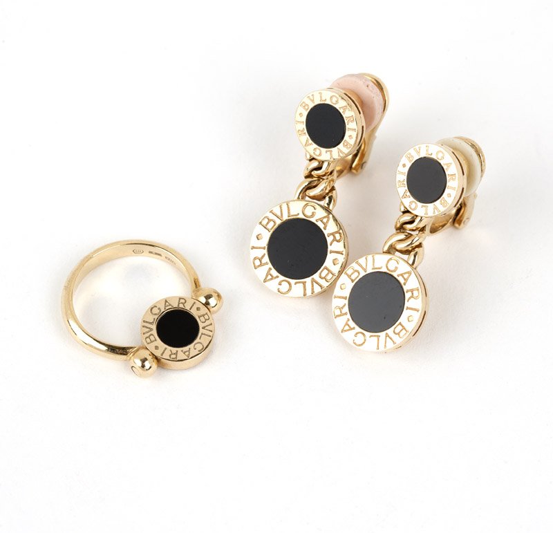 A pair of gold and onyx earclips & ring, Bulgari: Stamped 750, Made In Italy, ''Bvglari-Bvglari'', 18K gold pendant earclips with black onyx together with a flip ring, each with boxes, est: $1000/1500