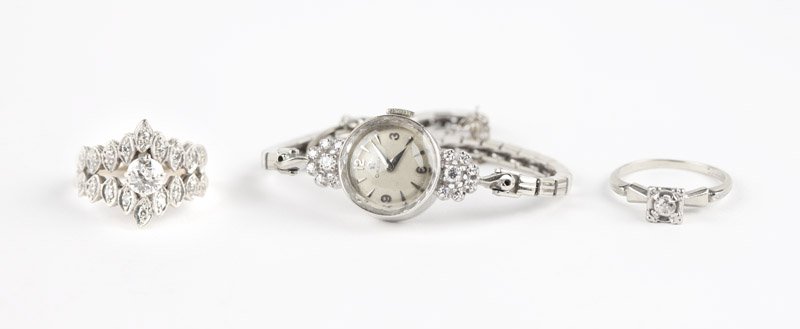 A collection of diamond and white gold jewelry: Featuring a lady's 14K white gold Omega watch, dial and movement signed Omega, 17 jewel unadjusted, with full and single-cut diamond accents at lugs, an 18K white gold and diamond ring, a 14K white go
